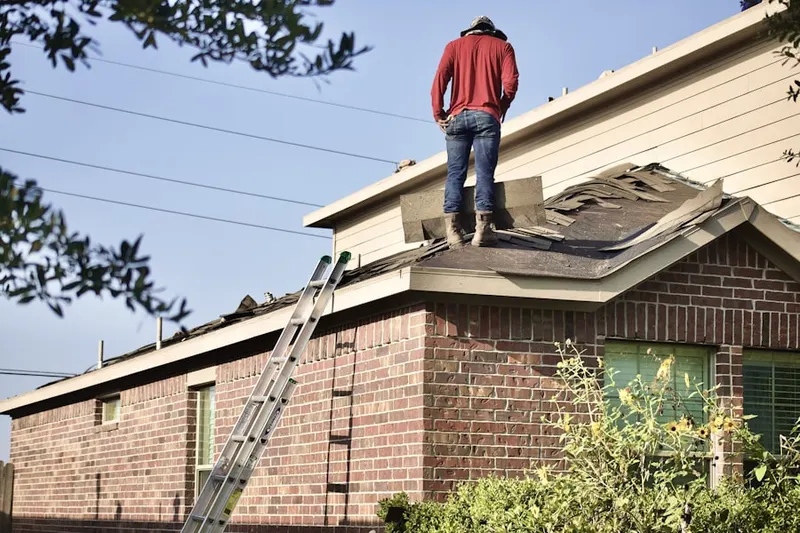 Professional roofer working on a residential roof in Nebraska City